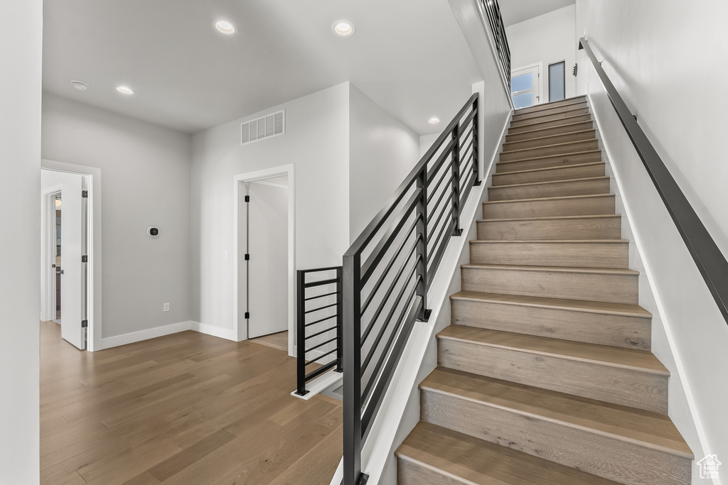 Staircase with hardwood / wood-style flooring