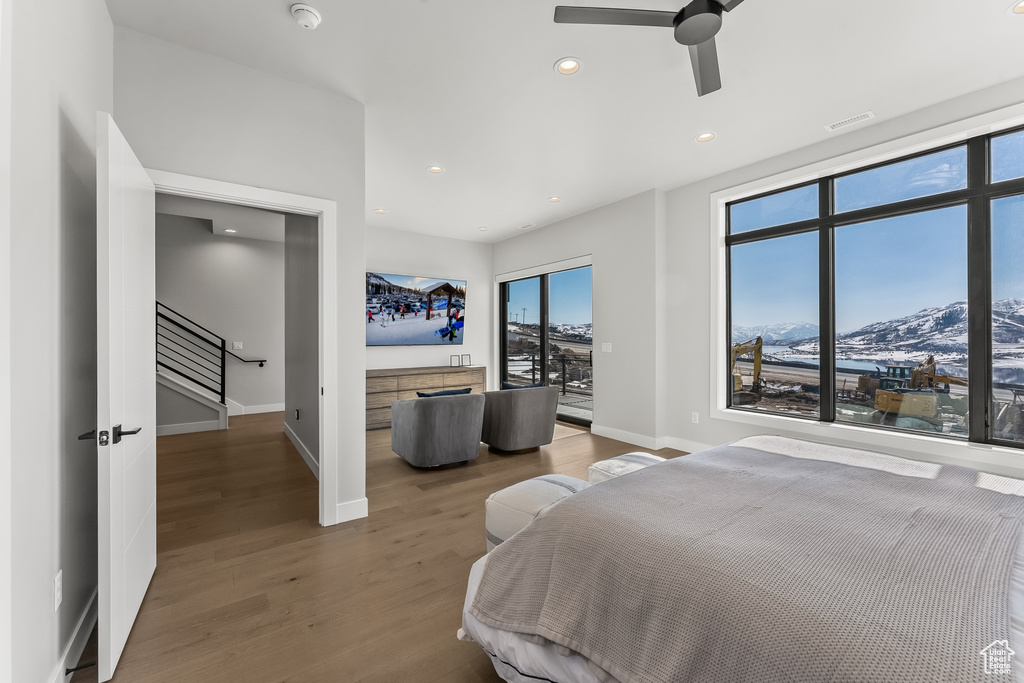 Bedroom with a mountain view, ceiling fan, access to exterior, and light hardwood / wood-style floors
