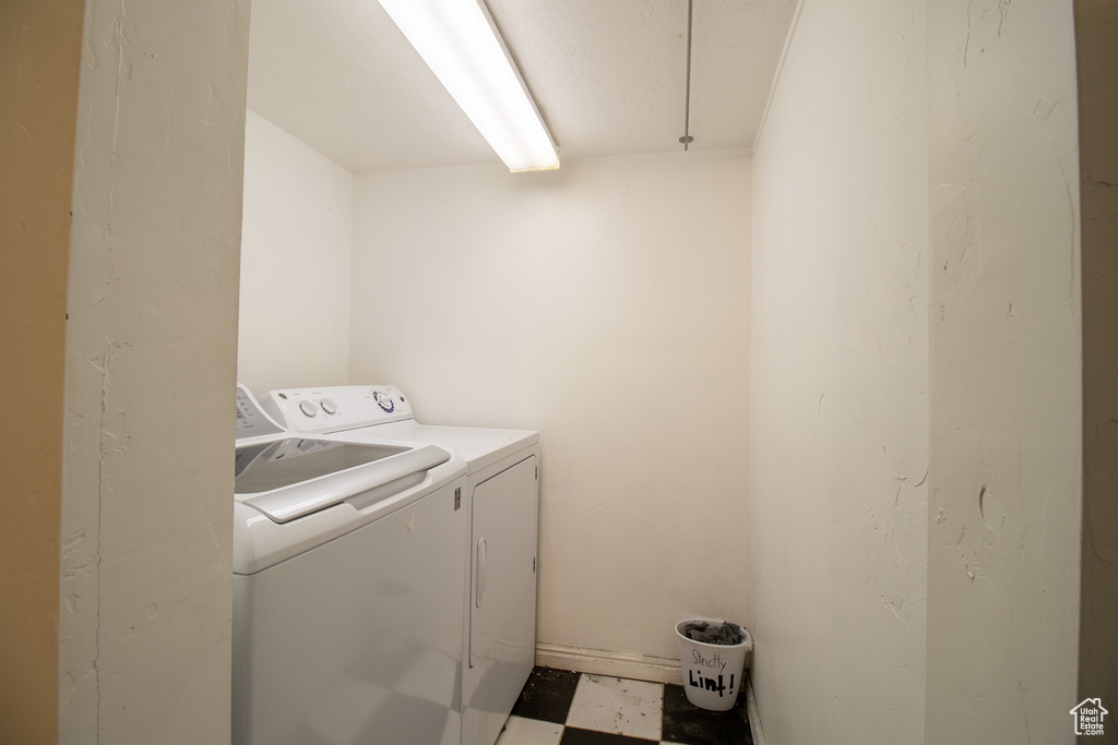 Washroom featuring independent washer and dryer and tile floors