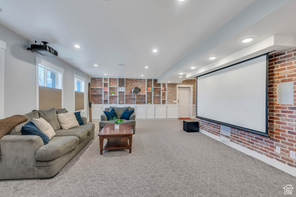 Home theater room featuring light colored carpet