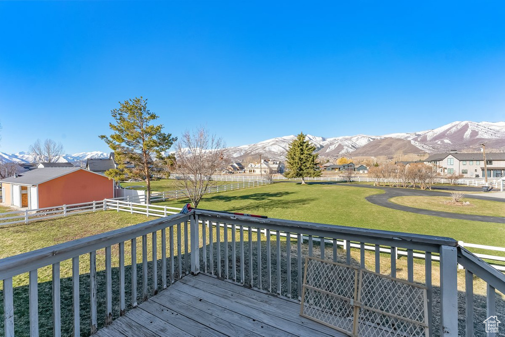 Wooden terrace with a mountain view and a yard