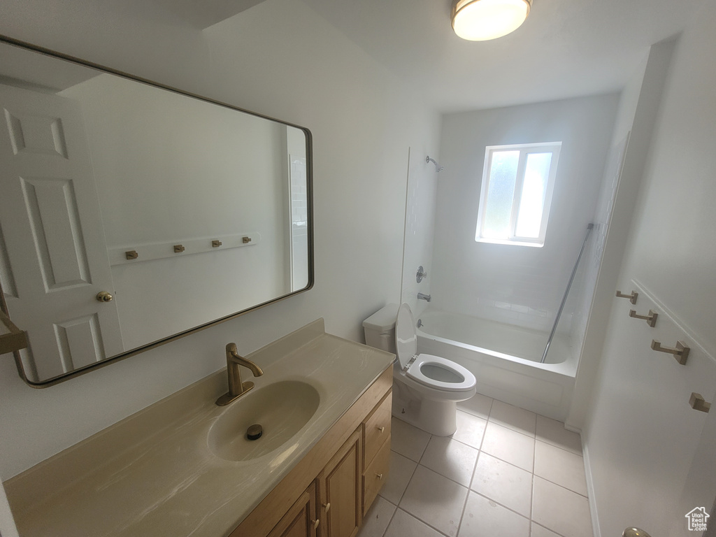 Full bathroom with bathtub / shower combination, vanity, tile floors, and toilet