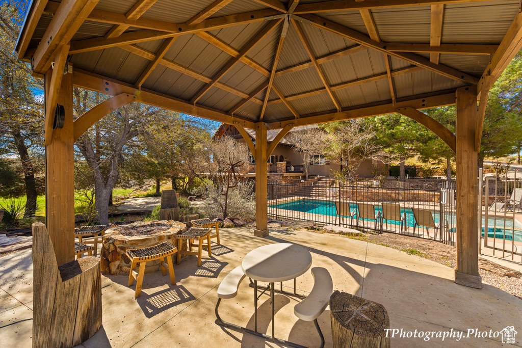 View of patio / terrace featuring a community pool and a gazebo
