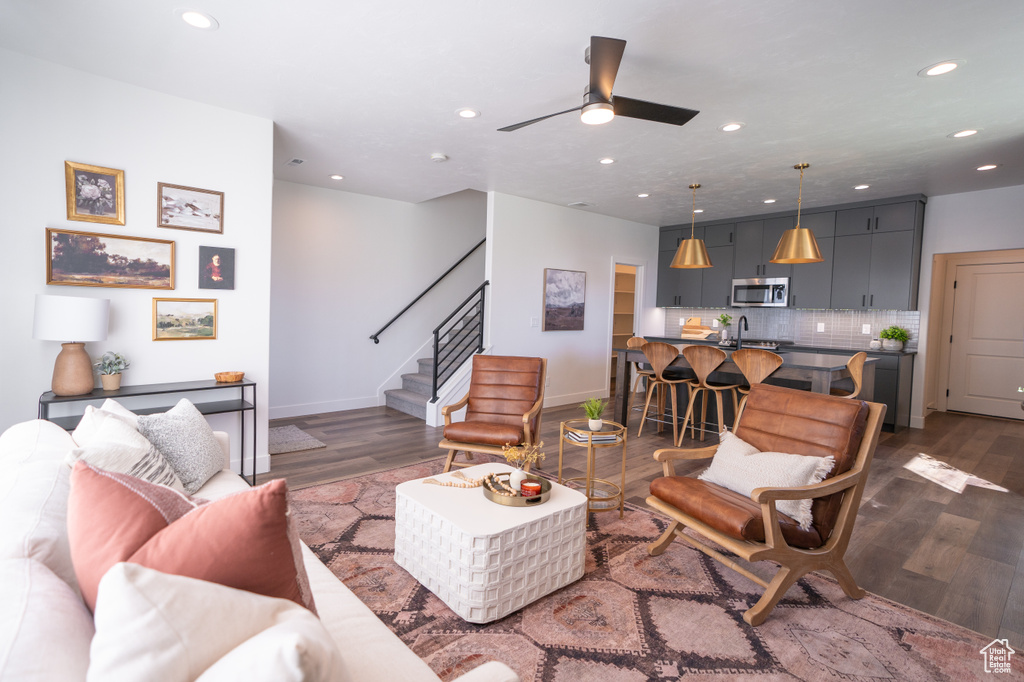 Living room featuring sink, ceiling fan, and dark hardwood / wood-style flooring
