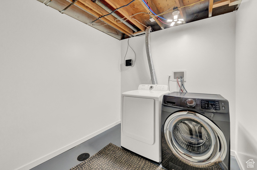 Clothes washing area featuring washing machine and dryer and hookup for a washing machine