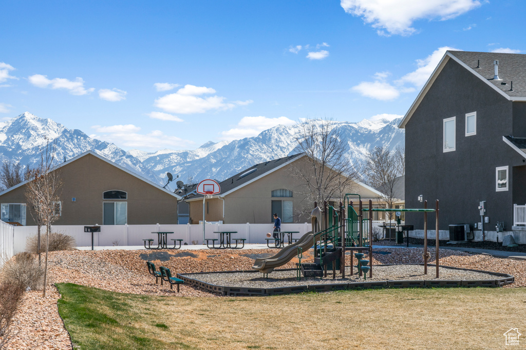 Exterior space featuring central AC, a mountain view, and a playground