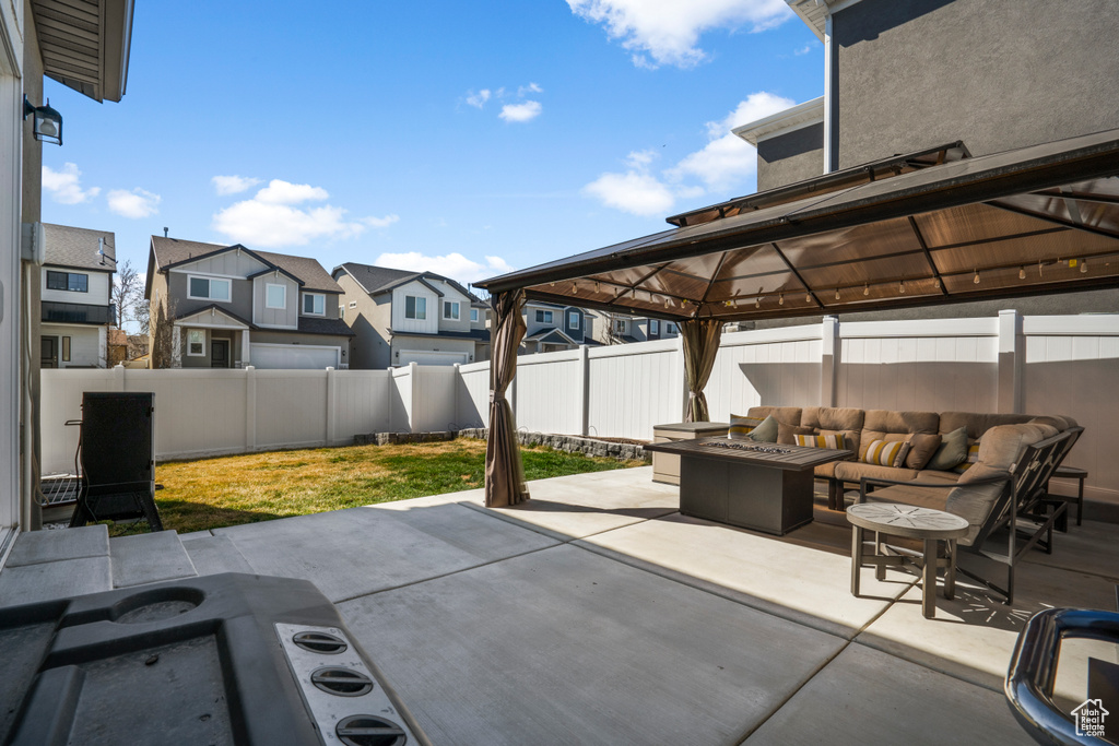 View of terrace with an outdoor living space with a fire pit and a gazebo