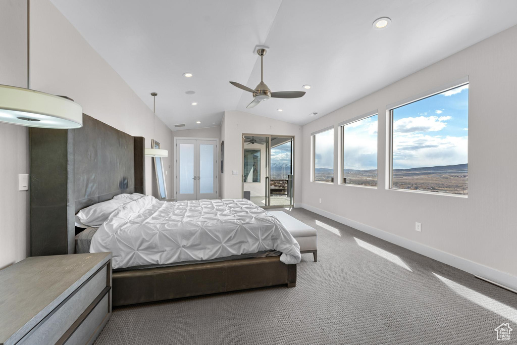 Bedroom featuring lofted ceiling, access to outside, multiple windows, and ceiling fan