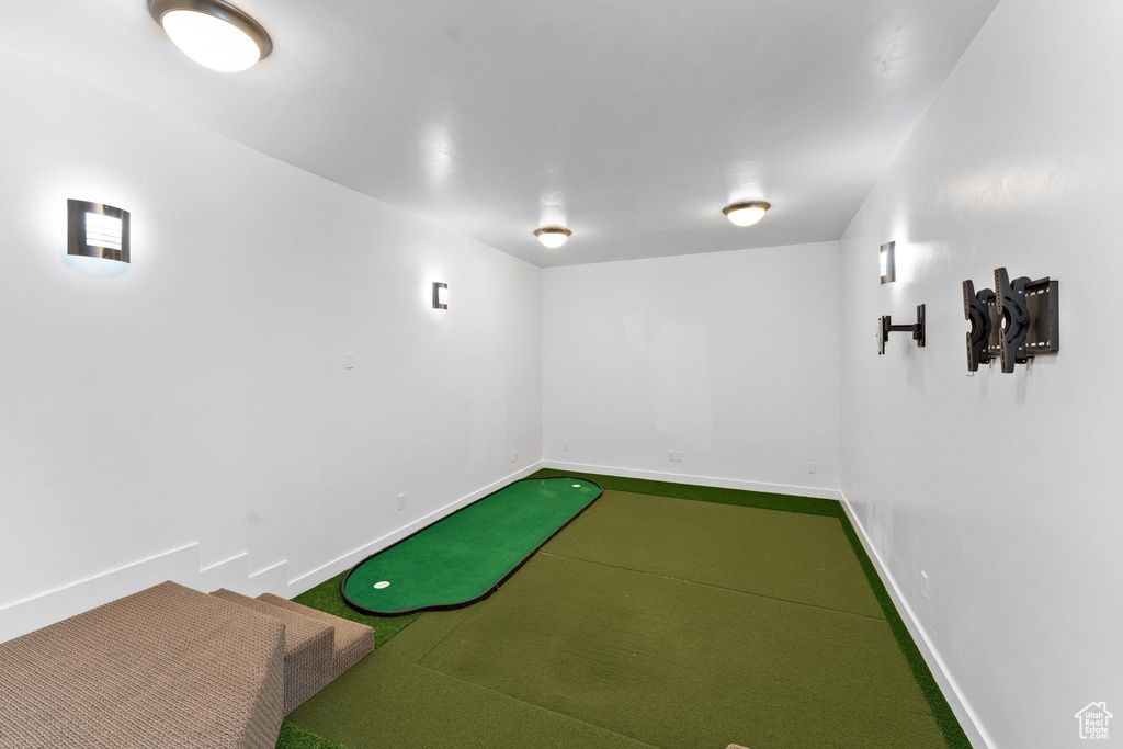 Rec room with golf simulator and carpet flooring