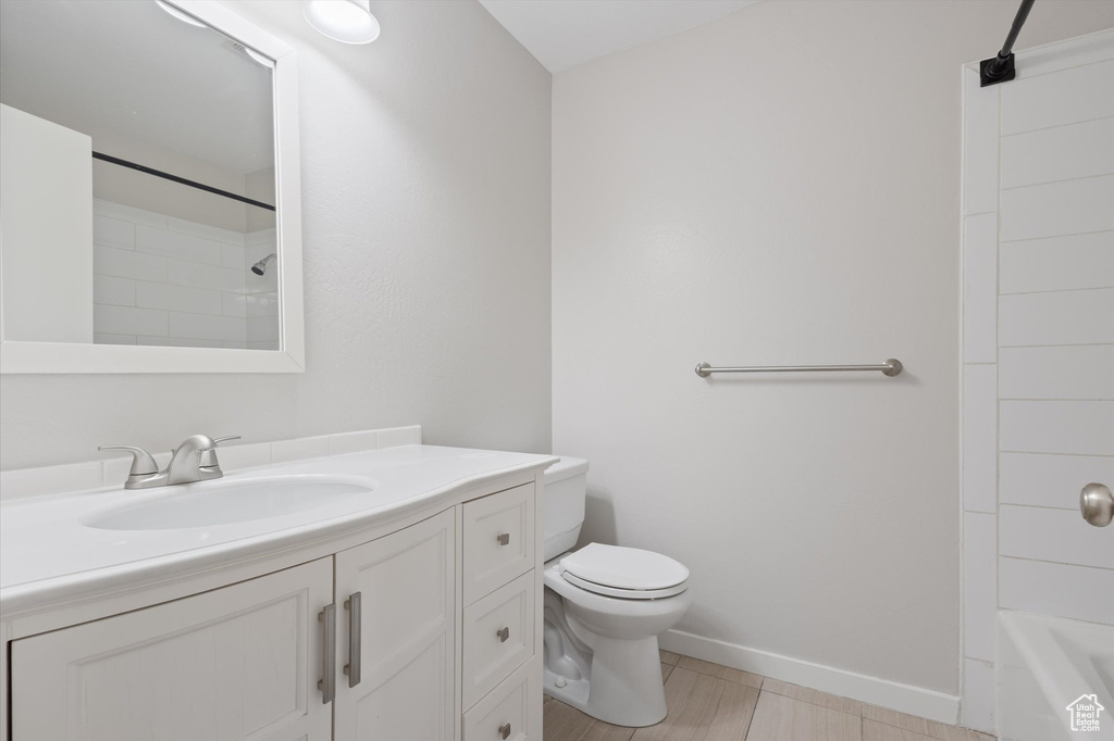 Full bathroom featuring shower / washtub combination, toilet, tile floors, and vanity
