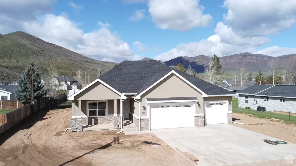 View of front of home featuring a garage and a mountain view