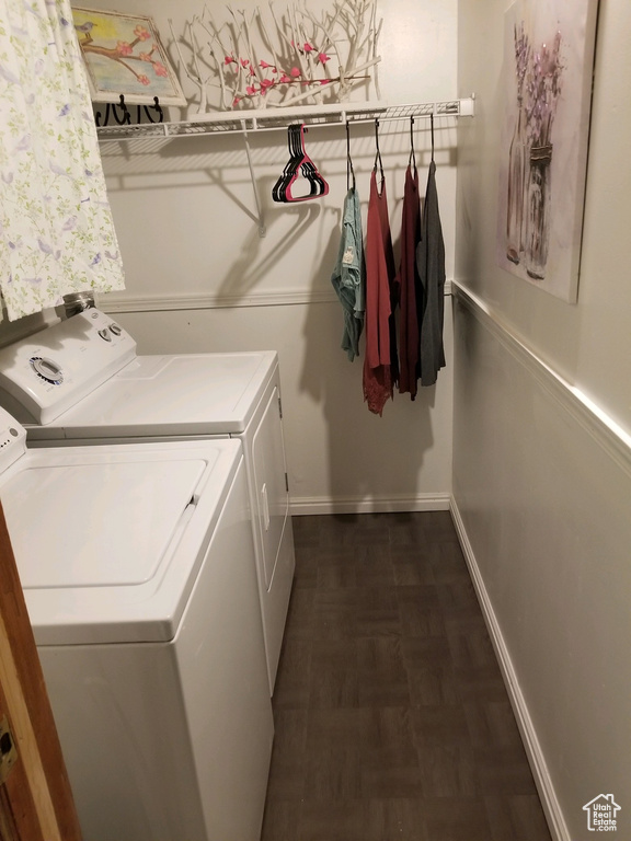 Washroom featuring separate washer and dryer and dark hardwood / wood-style floors