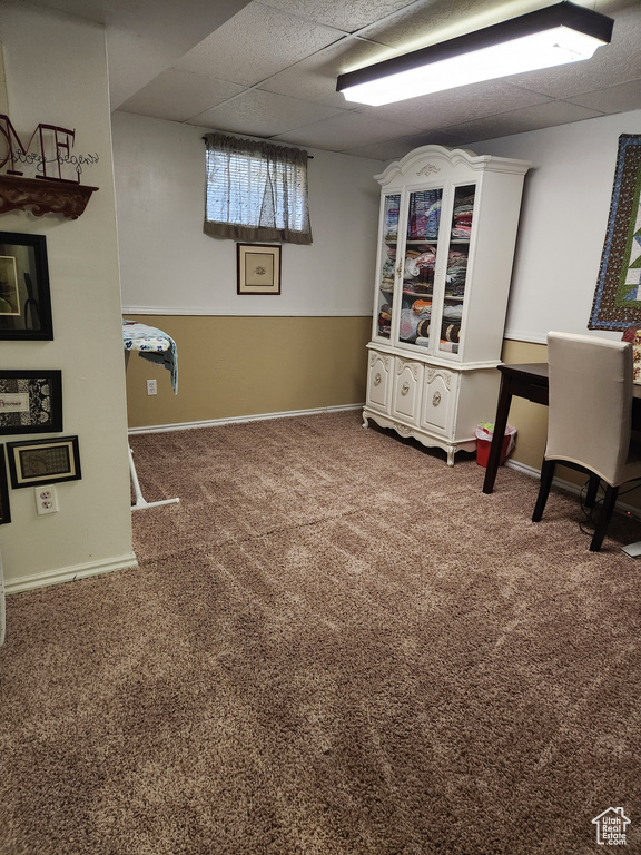 Interior space featuring carpet floors and a drop ceiling