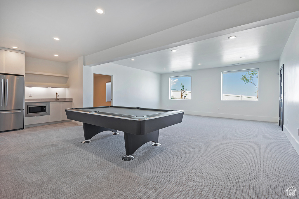 Rec room featuring billiards, sink, and light colored carpet