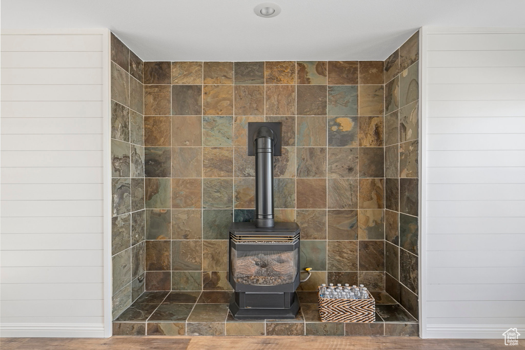 Room details with a wood stove and tiled shower