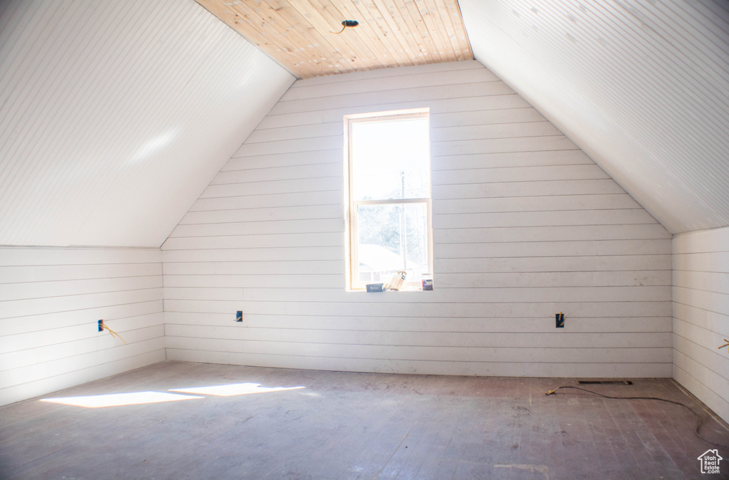 Bonus room with lofted ceiling and wood-type flooring