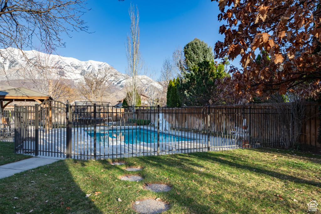 View of swimming pool featuring a mountain view and a yard