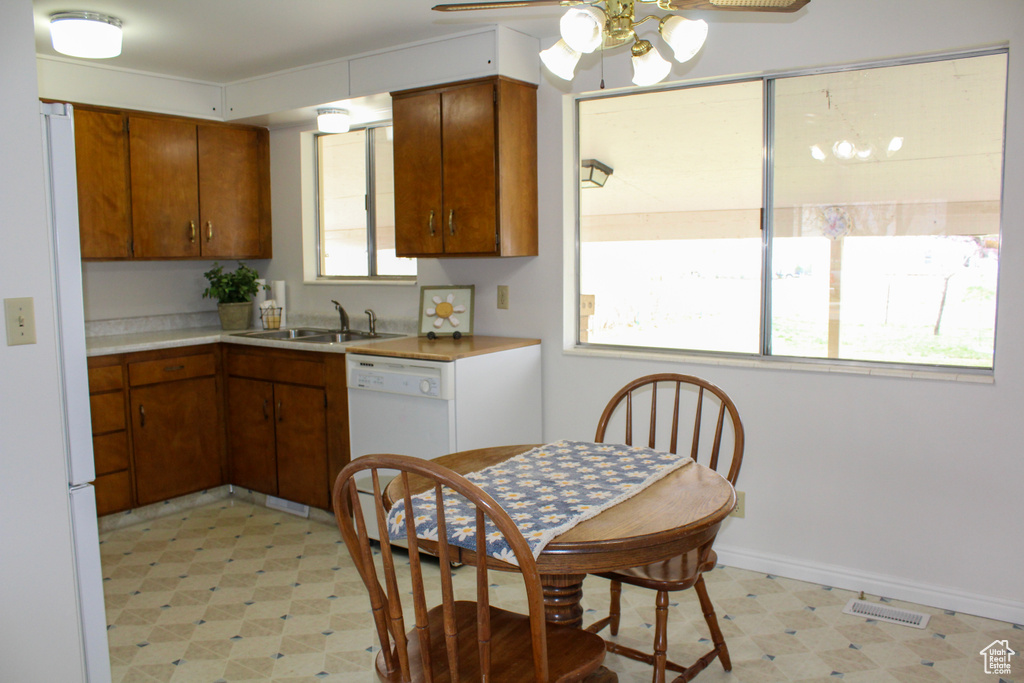 Kitchen featuring plenty of natural light, ceiling fan, and light tile flooring
