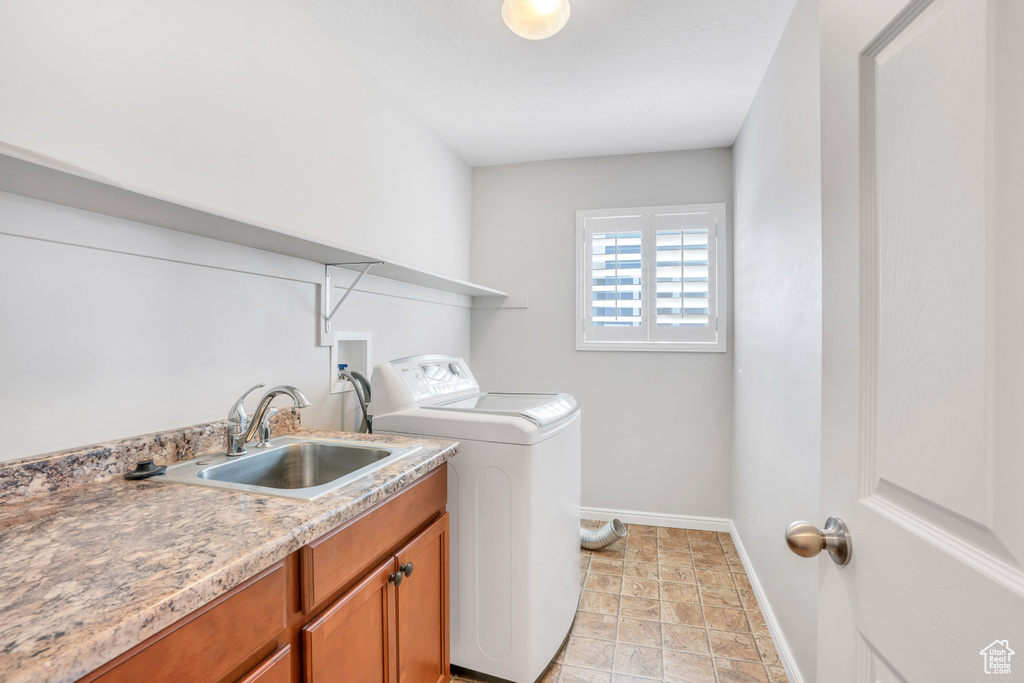 Laundry area with cabinets, sink, light tile floors, and washer / clothes dryer