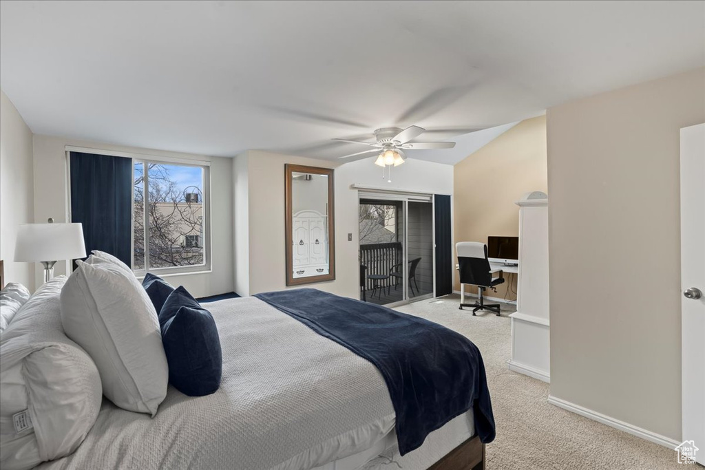 Carpeted bedroom featuring access to outside and ceiling fan
