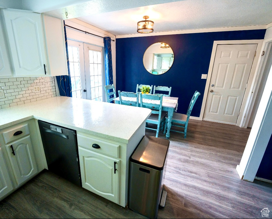 Kitchen featuring white cabinets, dishwasher, kitchen peninsula, and dark hardwood / wood-style floors
