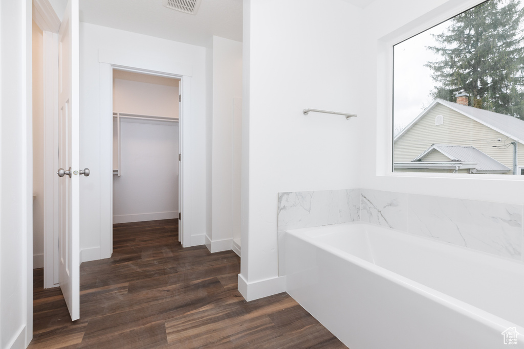 Bathroom featuring hardwood / wood-style flooring and a bathtub