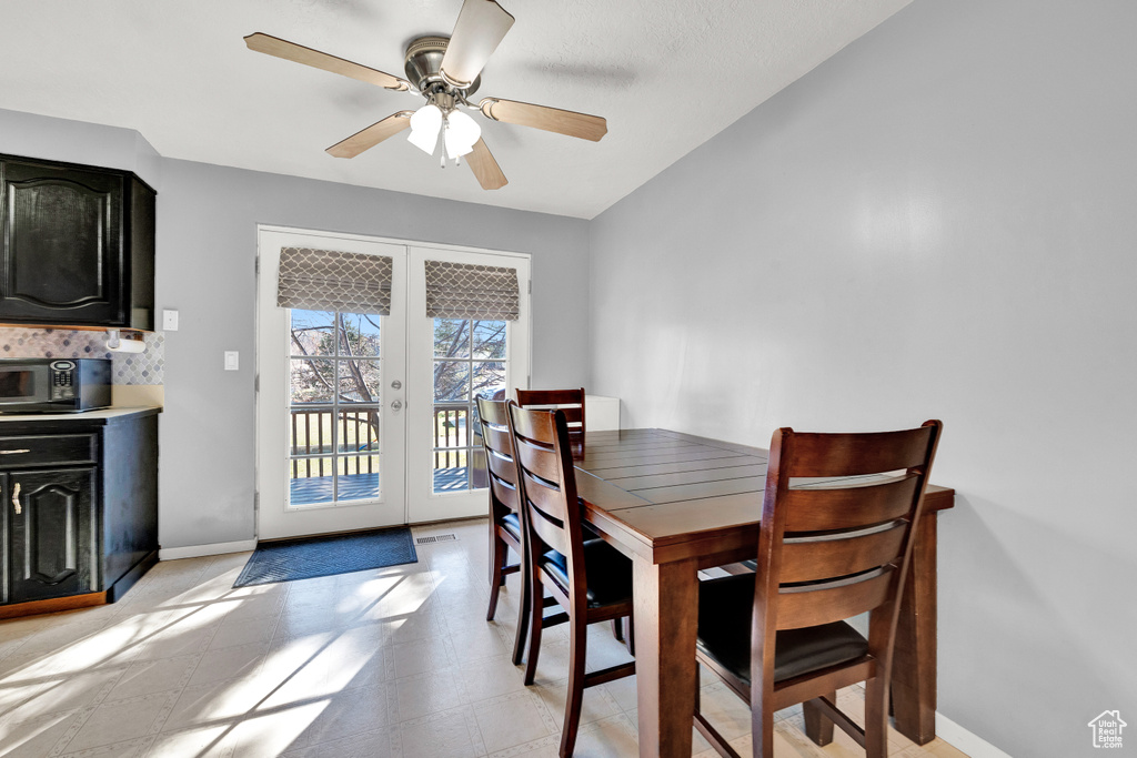 Dining room featuring ceiling fan and light tile floors