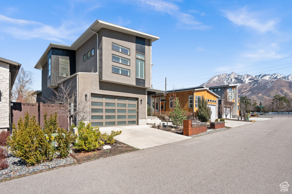 Contemporary home with a mountain view and a garage