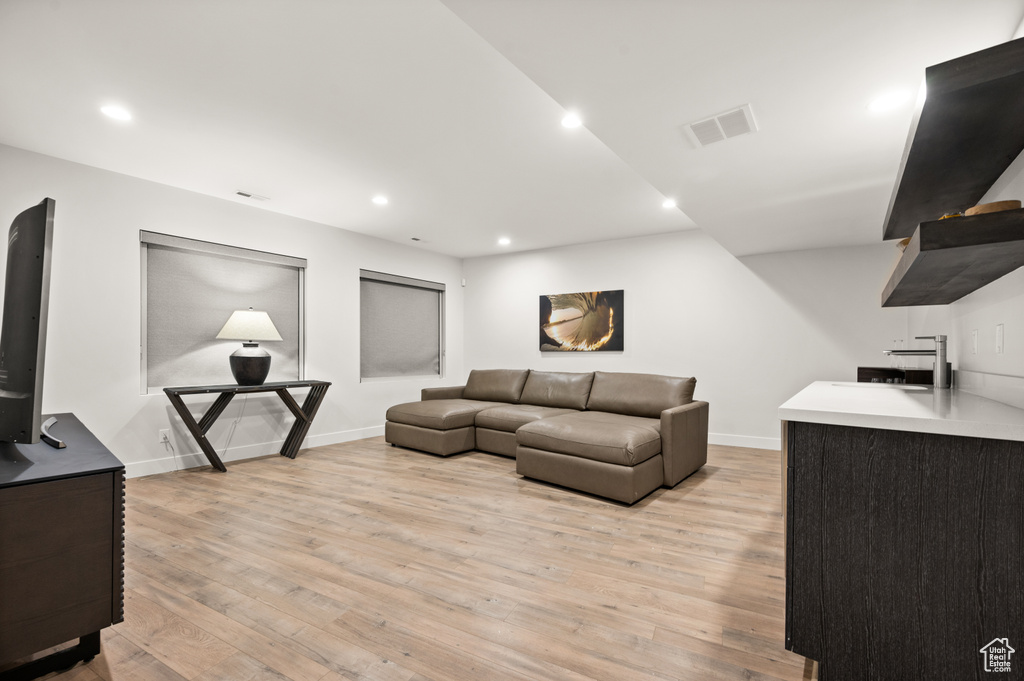 Living room with sink and light hardwood / wood-style floors