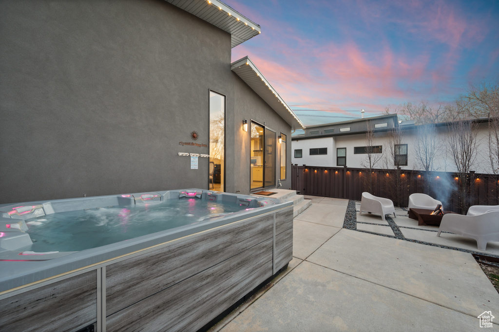 Patio terrace at dusk with a hot tub