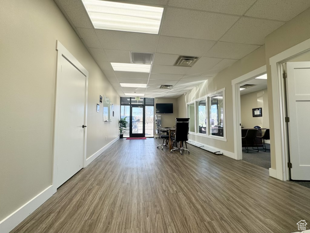 Hall featuring french doors, a drop ceiling, and hardwood / wood-style flooring