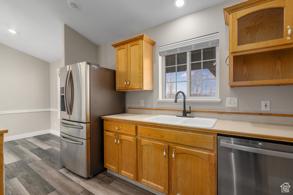 Kitchen featuring dark wood-type flooring, sink, and stainless steel appliances