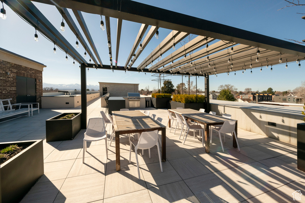 View of patio / terrace featuring exterior kitchen and a pergola
