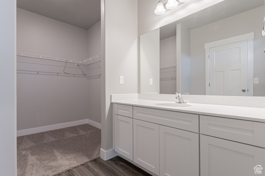 Bathroom featuring vanity and hardwood / wood-style floors