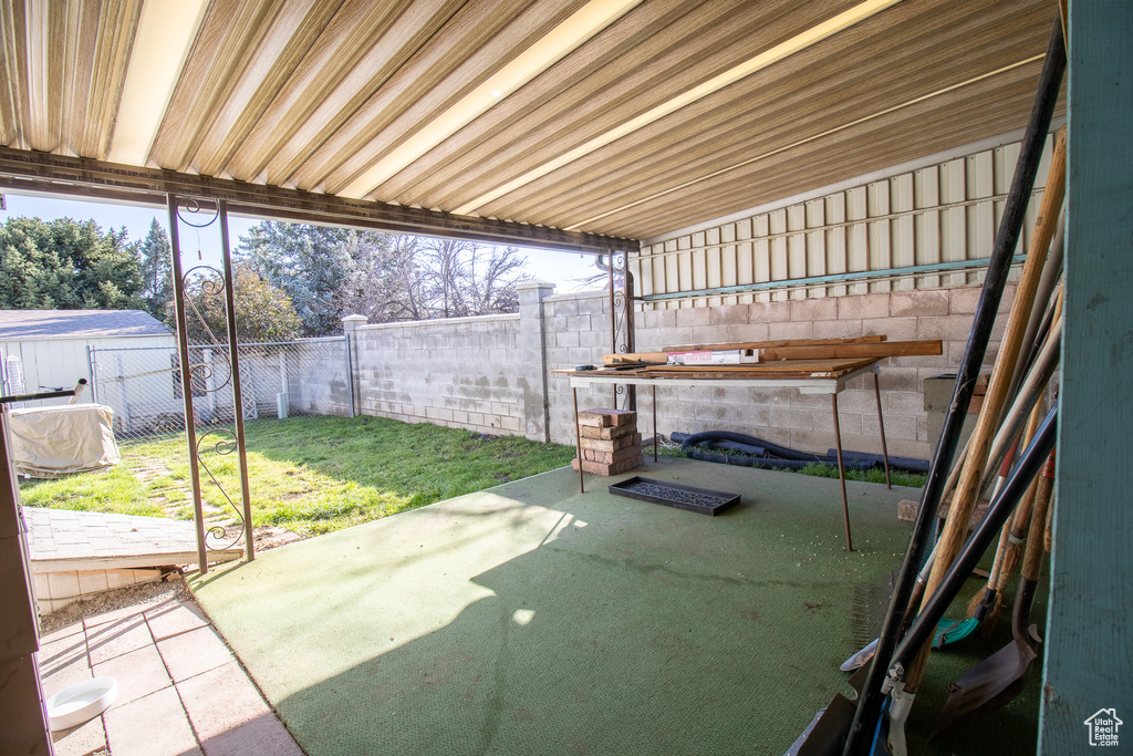 View of patio featuring a storage shed