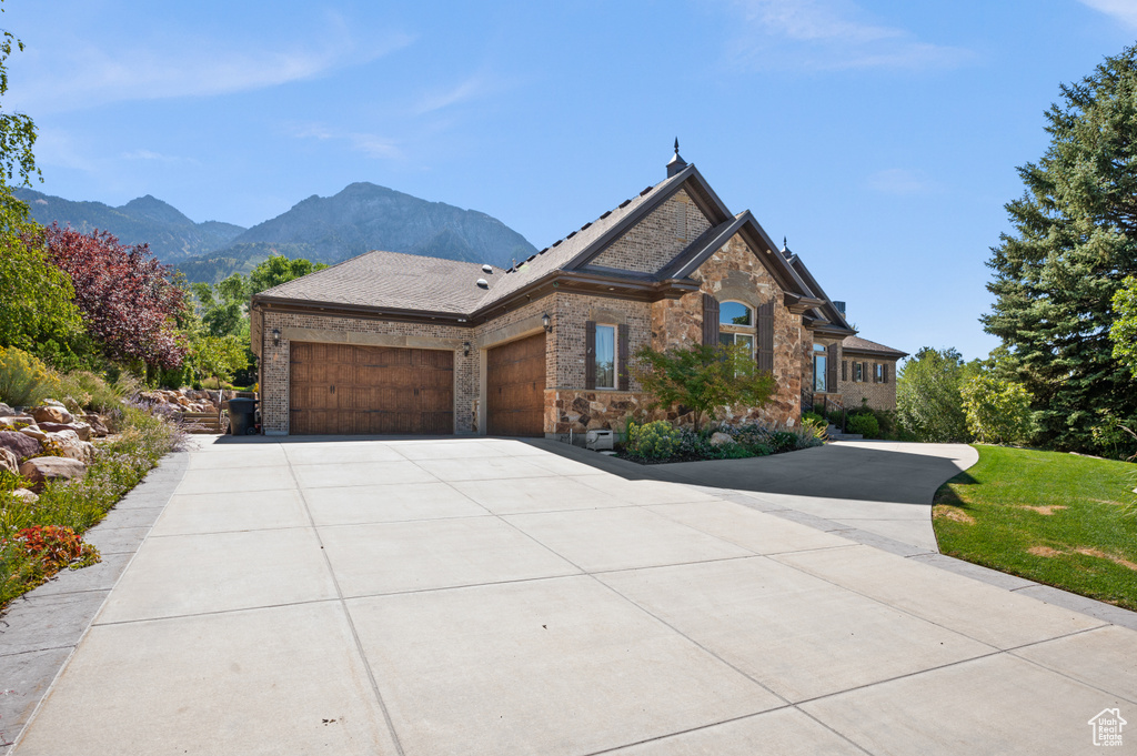 View of front of property featuring a mountain view and a garage