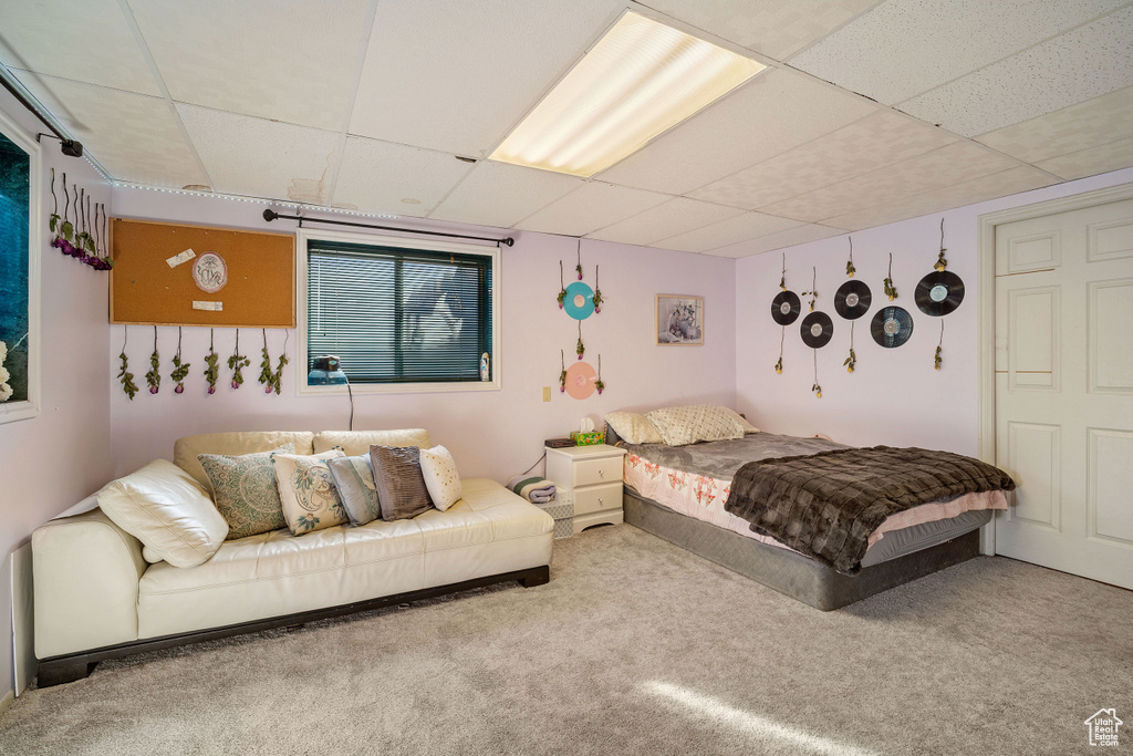 Bedroom with a drop ceiling and carpet floors