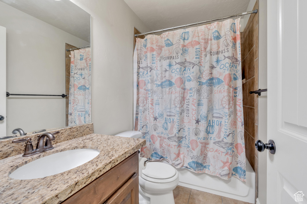 Full bathroom with shower / tub combo with curtain, toilet, tile flooring, and oversized vanity