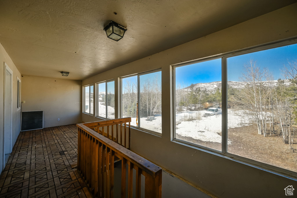 Unfurnished sunroom featuring a mountain view