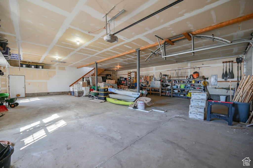 Garage with a workshop area and a garage door opener