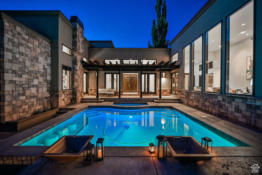 Pool at twilight with a patio
