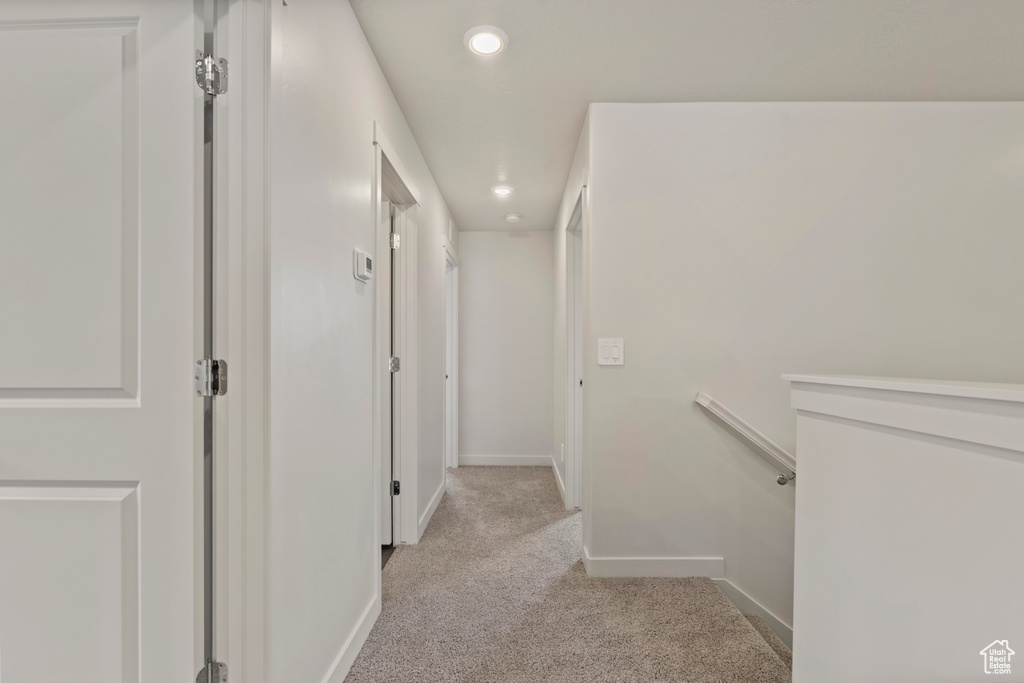 Corridor with light colored carpet