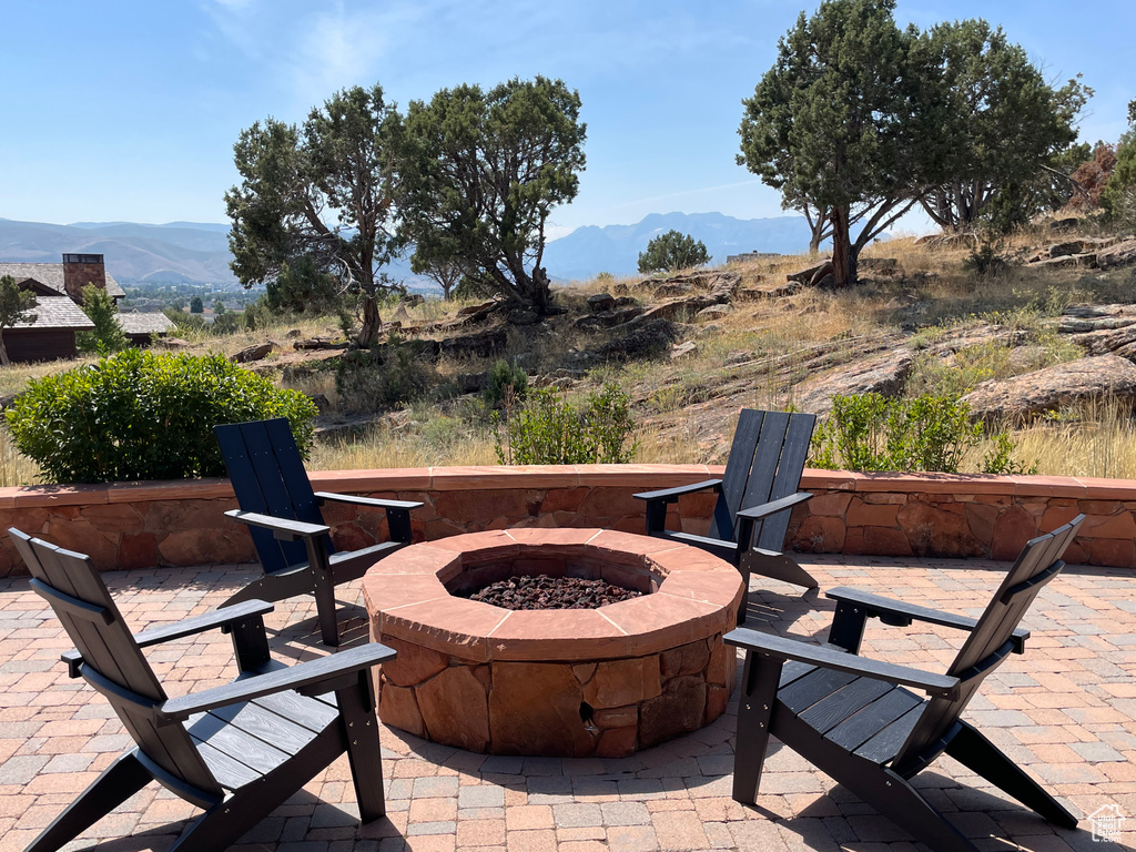 View of patio / terrace featuring an outdoor fire pit and a mountain view