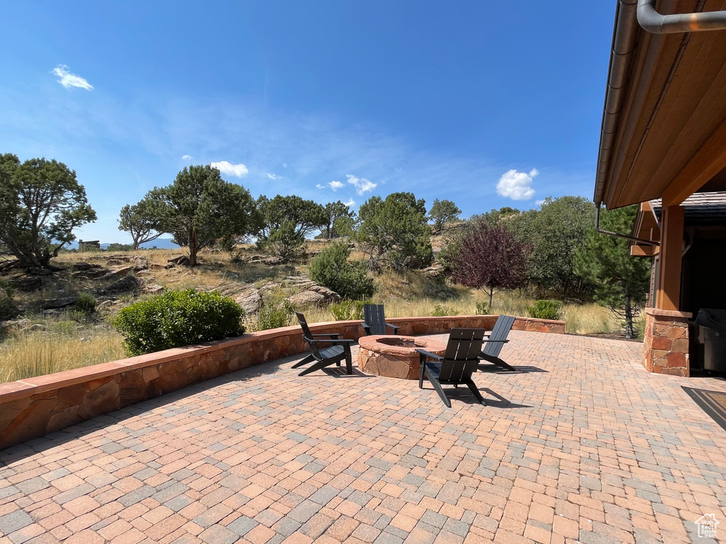 View of patio with an outdoor fire pit