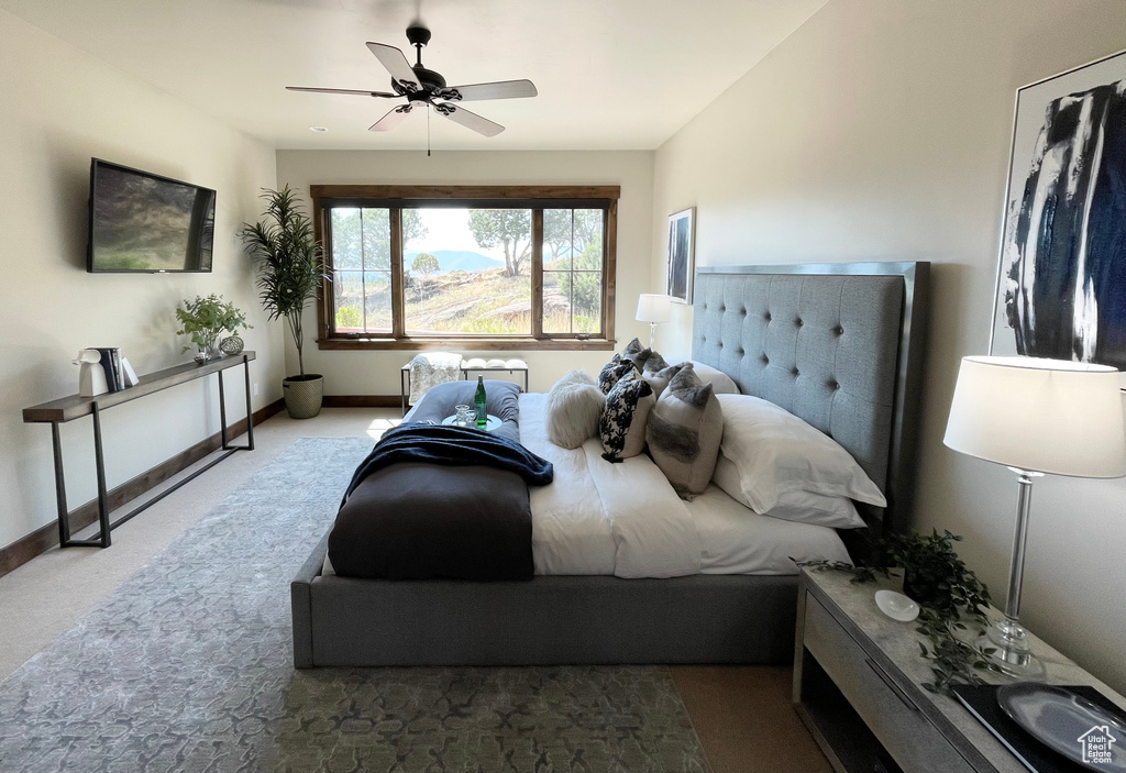 Carpeted bedroom with ceiling fan