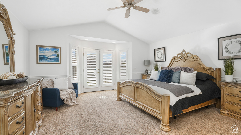 Carpeted bedroom with french doors, vaulted ceiling, access to exterior, and ceiling fan