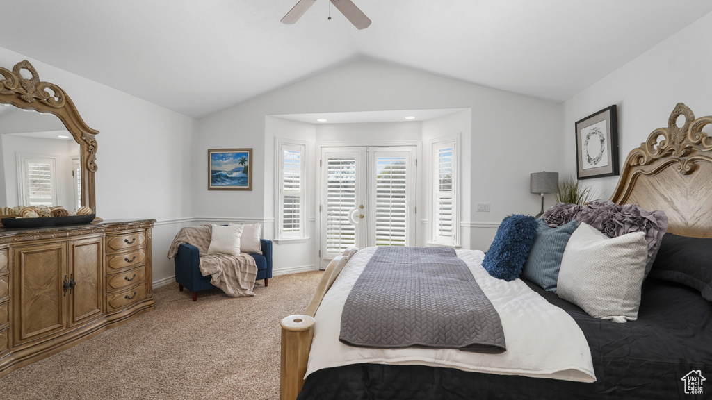 Carpeted bedroom with french doors, ceiling fan, lofted ceiling, and access to exterior