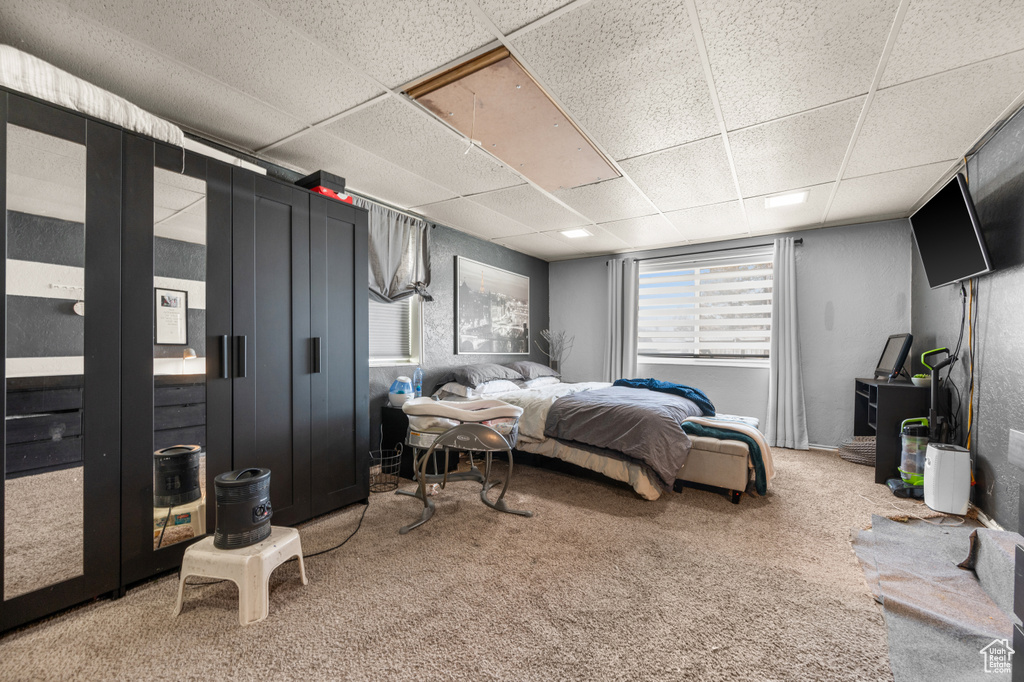 Carpeted bedroom with a drop ceiling