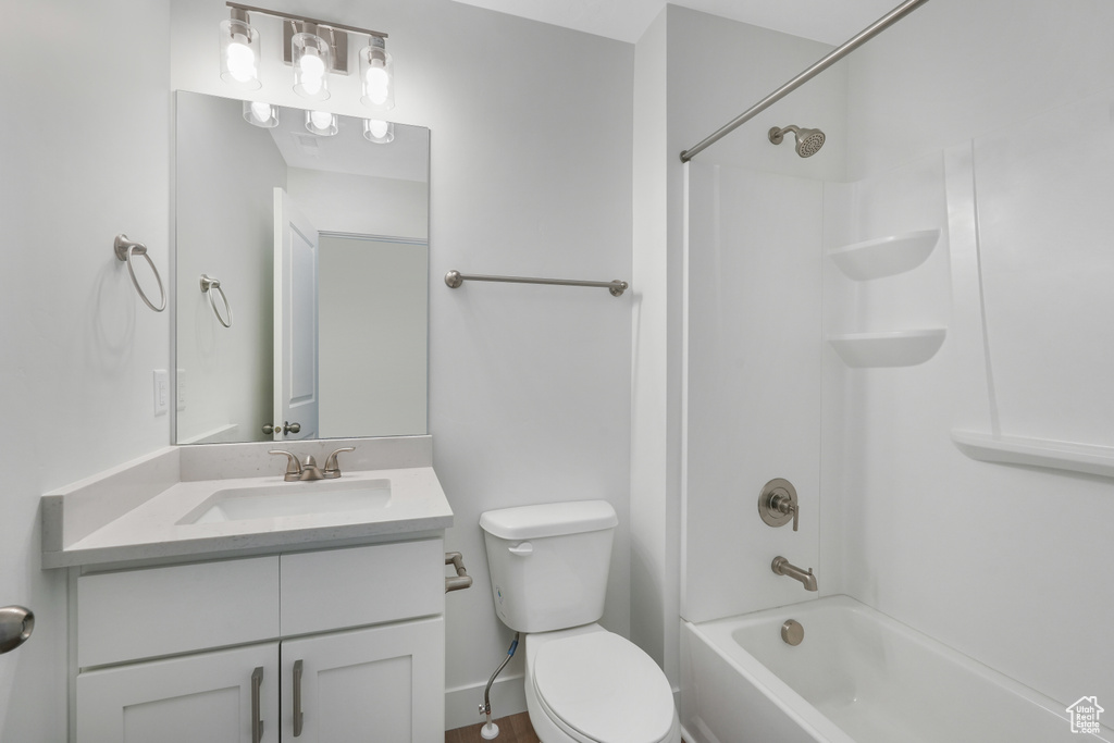 Full bathroom with bathing tub / shower combination, toilet, and vanity with extensive cabinet space