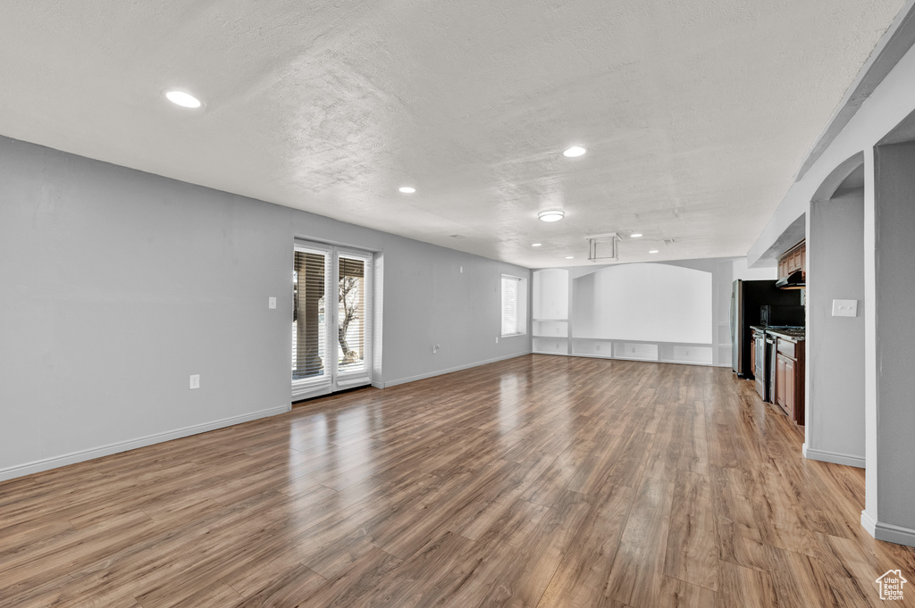 Unfurnished living room featuring hardwood / wood-style flooring